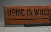 "Home is Where the Heart Is" quote beautifully carved as a Wisdom In Wood® inspirational wall art saying.- Heritage Oak Finish